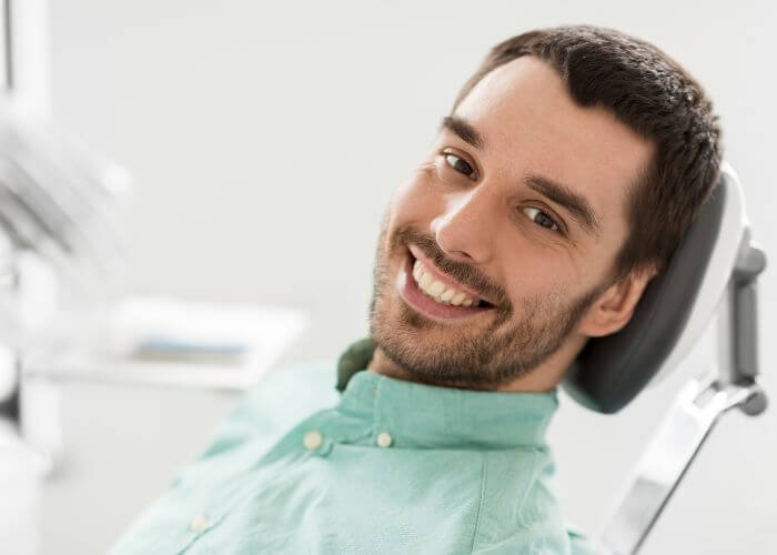 men sitting on dental chair