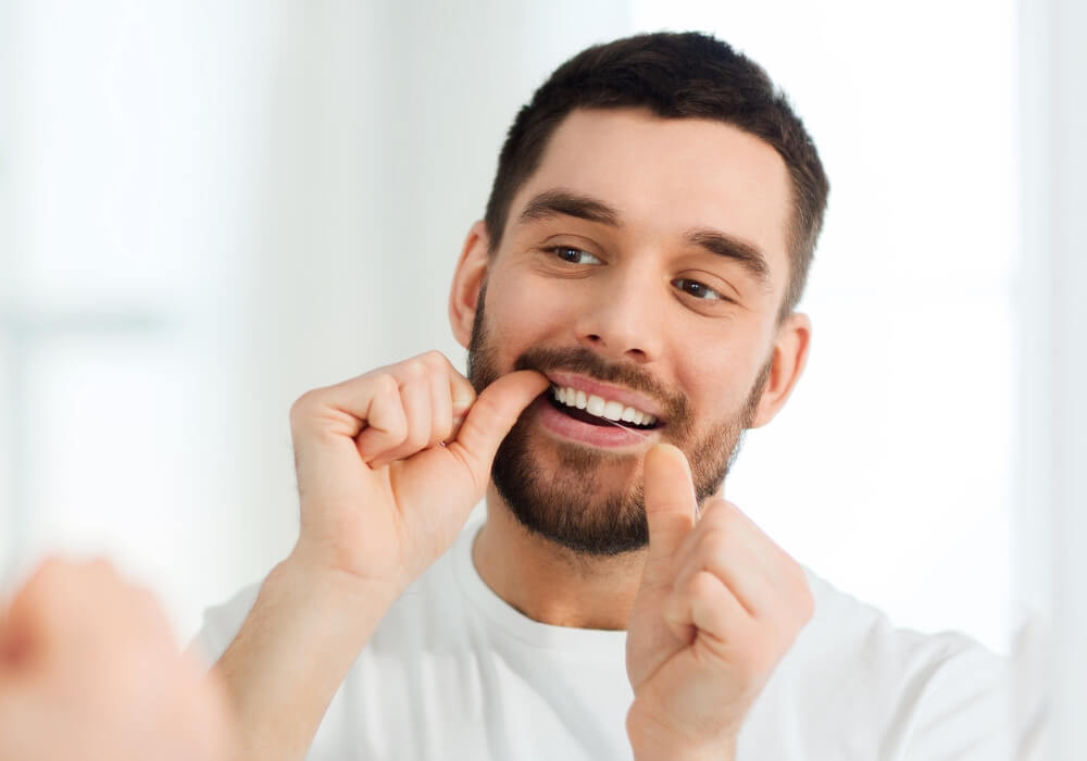 A man brushes his teeth