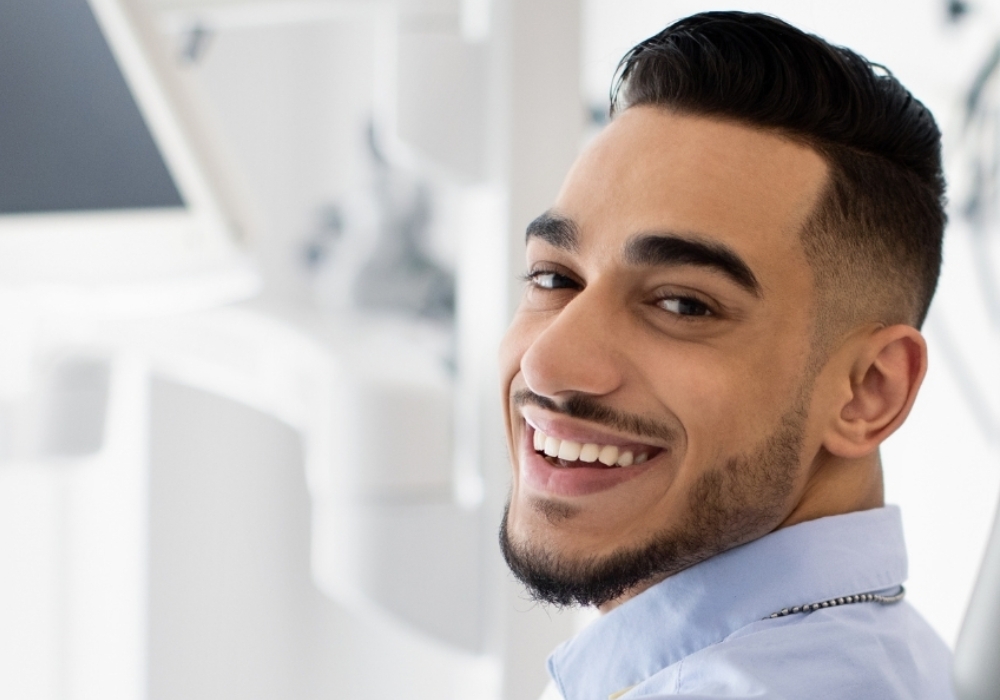 A man comfortably sitting in a dental office chair