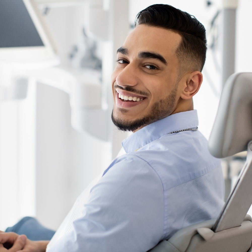 A man comfortably sitting in a dental office chair