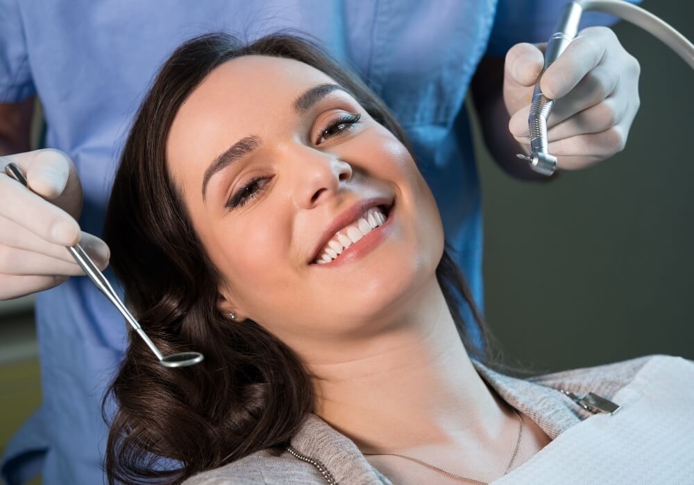 A woman smiles during her dental checkup