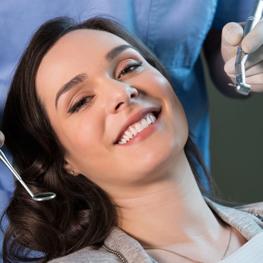 A woman smiles during her dental checkup