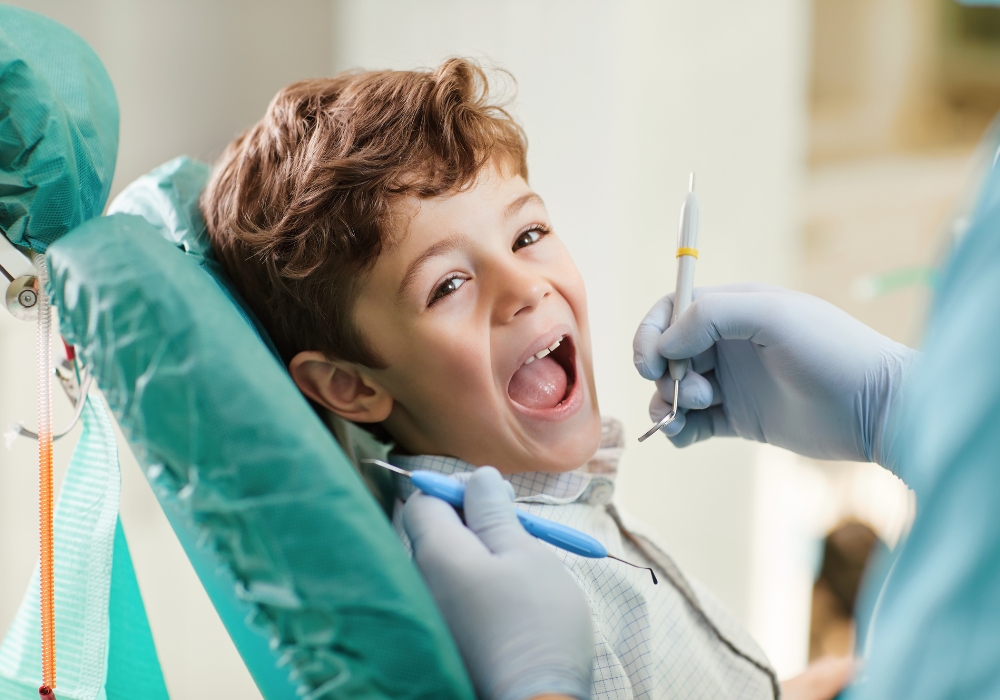 A young boy seated in a dentist chair